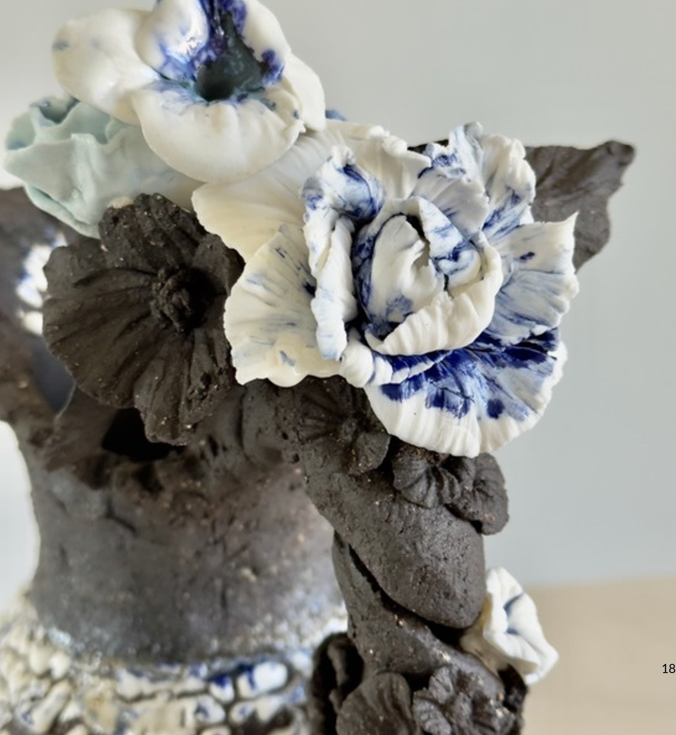 Detail of porcelain roses with cobalt blue glaze on dark stoneware